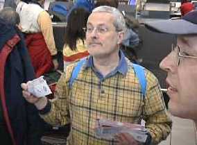 Chairman Rien Frankenhuis distributing boarding passes at Amsterdam Airport Schiphol