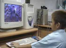 Thai youth playing video-games in an internetcafe