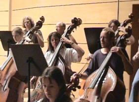 The double bass section warming up.